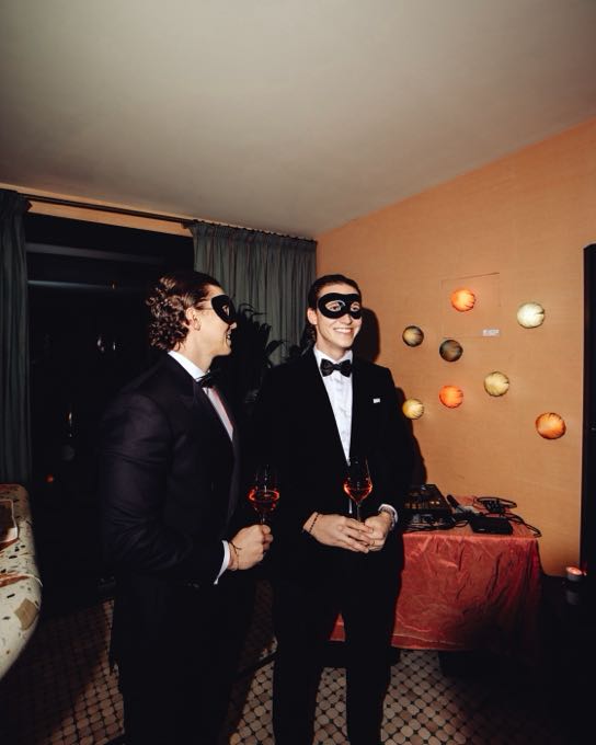 Guests in dinner jackets and eye masks at an evening event