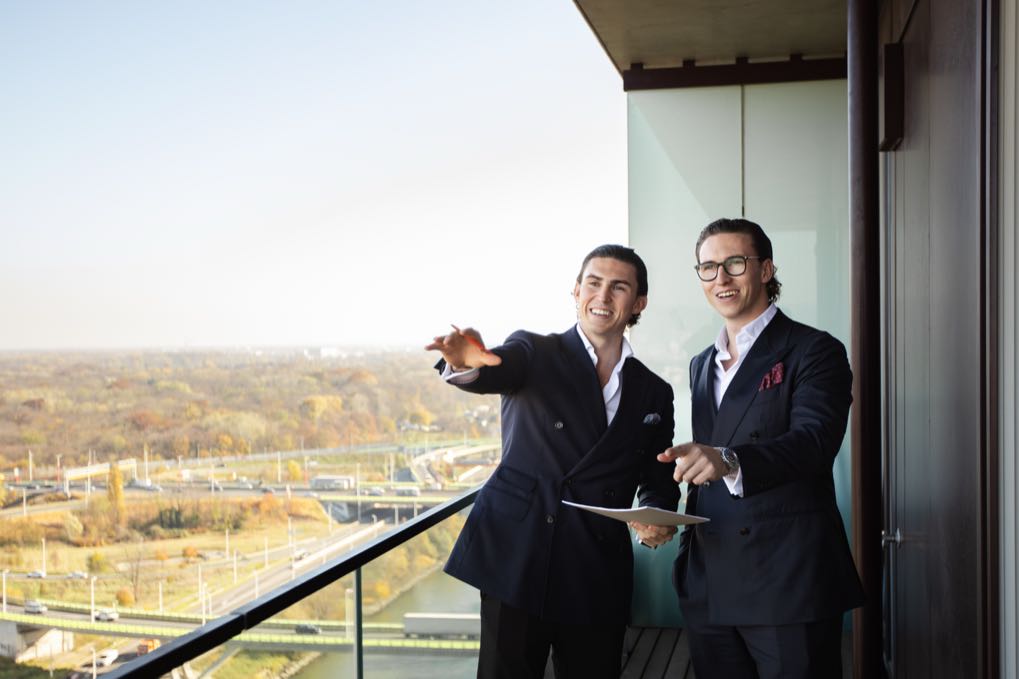 Jürgen and Matthias Nussbaumer on a balcony overlooking the city