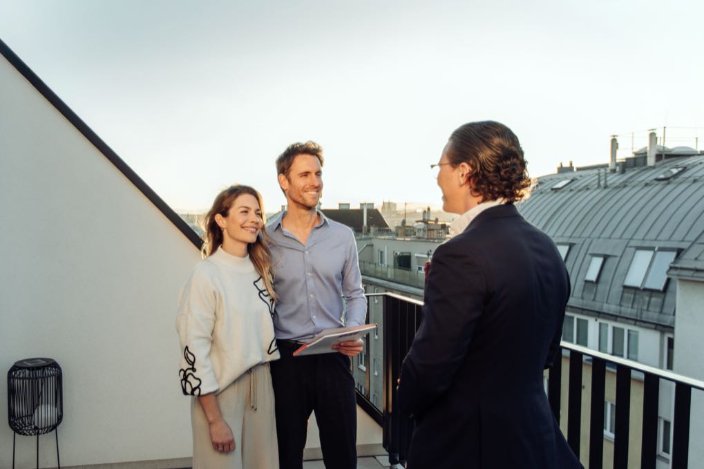 Conversation with a couple on a rooftop terrace in the evening light