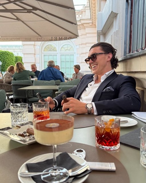 Man in sunglasses having lunch on a sunny terrace